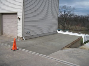 Keystone retaining wall and concrete pad The pad after it has been poured and the joints cut.